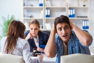 Young family filing divorce papers with lawyer