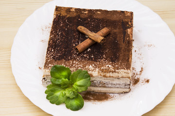 delicious tiramisu on wooden background