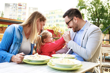 family enjoying pasta