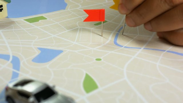 Close up shot hand of woman pinning color pin at the map meta phor planning for transport and travel