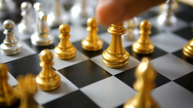 Close up shot hand of man and woman play gold and silver chess metaphor business compettition concept select focus shallow depth of field