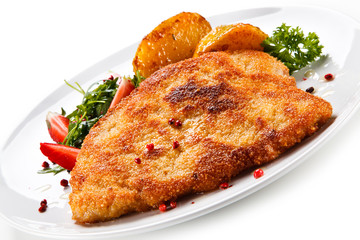 Fried pork chop, baked potatoes and vegetable salad
