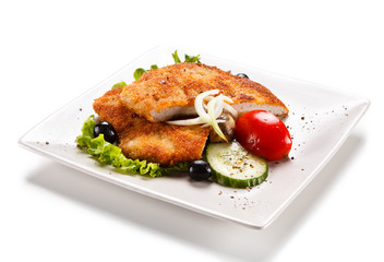 Fried pork chop and vegetable salad on white background
