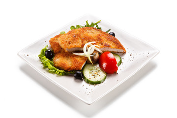 Fried pork chop and vegetable salad on white background