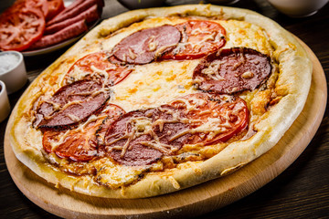 Pizza with salami, mushrooms and vegetables