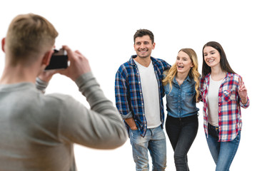 The four friends make a photo on the white background