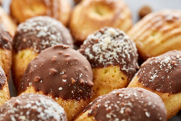 Tasty almond cookies arranged on white background, close-up, selective focus