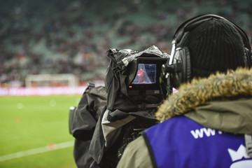 TV camera during football match.