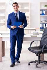 Fototapeta premium Young handsome businessman employee working in office at desk