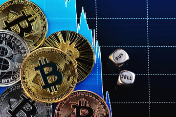Golden coins of bitcoin on graph  background with the dices.
