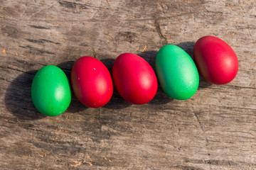 Painted Easter eggs on rustic wooden background