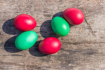 Painted Easter eggs on rustic wooden background