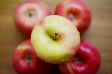 Red apples on wooden background