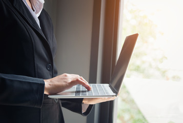 Business woman using laptop computer in a modern office