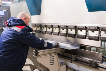 Operator working cut and bending metal sheet by high precision metal sheet bending machine, cnc...