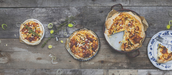 different delicious quiches on a wooden background
