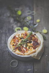 different delicious quiches on a wooden background