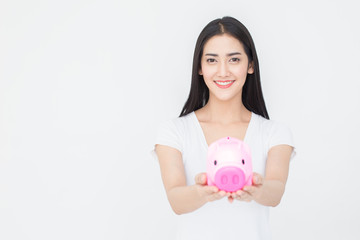 Fototapeta na wymiar Portrait of Attractive female holding piggy bank on white background.