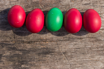 Painted Easter eggs on rustic wooden background
