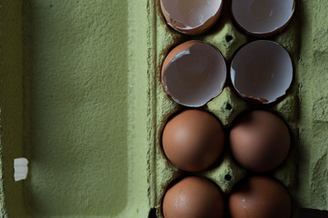 Top view - eggs cartoon box on table, close-up
