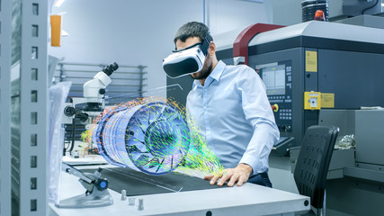 Factory Chief Engineer Wearing VR Headset Designs Engine Turbine on the Holographic Projection...
