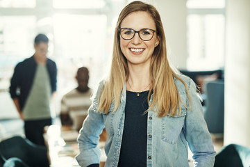 Smiling young designer at work in a modern office