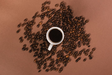 Top view of one cup of coffee on the brown background