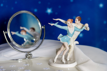 Figure skaters with reflection in a mirror