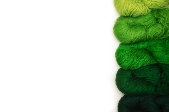Top view of green threads on the white background