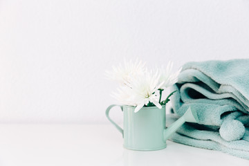 Minimalist  decorations with flowers and turquoise blanket