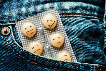 Pills in the jeans pocket. Concept of antidepressants