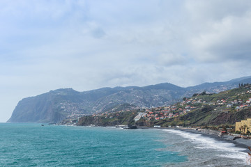 Landscape with the coastline and waves crushing on the shoreline on a sunny day