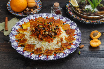 Iranian pilaf with orange zest, nuts and raisins, on a traditional plate