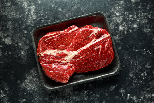 Fresh Raw braising steak on black tray