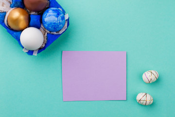 Colorful Easter eggs and blank card. Easter chicken eggs and polystyrene eggs on colorful background. Happy Easter holidays.