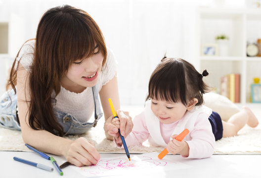 happy Mother and daughter drawing together