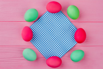 Frame from vintage color Easter eggs. Dyed Easter eggs with vintage napkin in center. Space for greeting text.
