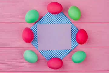 Easter dyed eggs on pink background. Frame from Easter painted eggs. Blank card for greeting.