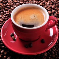Red coffee cup filled full espresso americano black with background various dark roasted beans scattered flat lay square format photo
