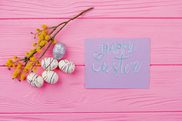 Happy Easter background with pussy willow. Easter styrofoam eggs, yellow pussy willow twig and greeting card. Spring and Easter holidays.