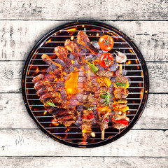 Top view of fresh meat and vegetable on grill placed on wood - obrazy, fototapety, plakaty