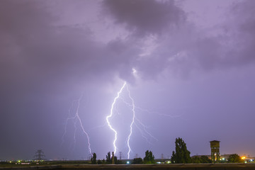 Naklejka na ściany i meble Lightning flash over a city lectricity blast storm