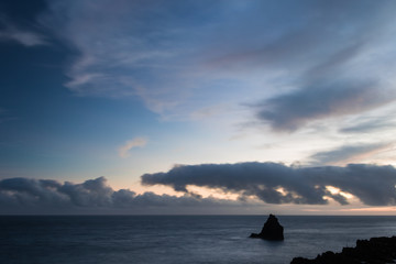 Landscape with unusual animal shaped clouds on the sky at the Atlantic Ocean coast