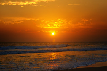 Beach of the ocean and golden sun rise.