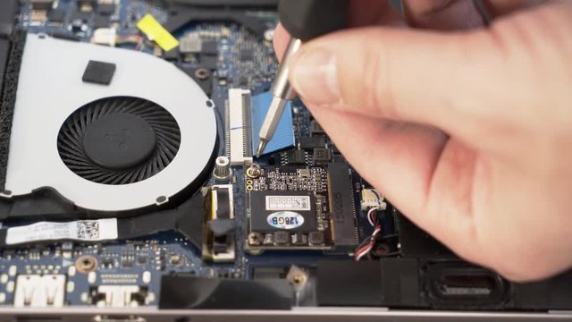 Installing the SSD Disk into the msata slot on the laptop. Installing a hard drive on a laptop. Laptop repair.