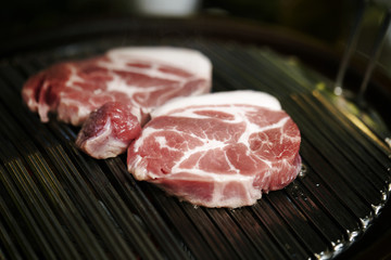 raw meat on grill