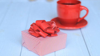 close-up background image of red Cup and gift box on light background.