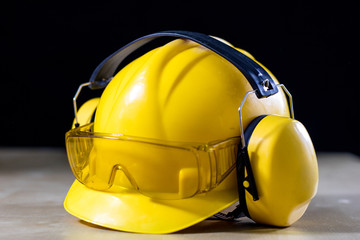 Protective clothing and tools lying on the workshop table. Buy and helmet for a construction worker.