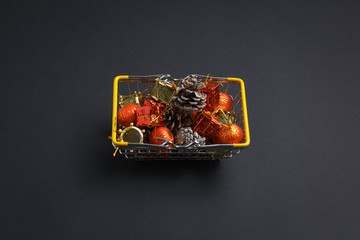 basket with gifts, deer, stars and fir-trees, flat lay on a dark blue background, holiday greetings