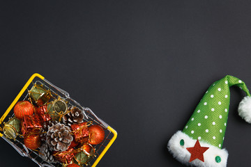 basket with gifts, deer, stars and fir-trees, flat lay on a dark blue background, holiday greetings